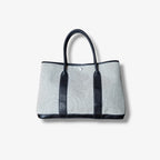 Sac Hermès Garden Party en toile beige et cuir noir seconde main